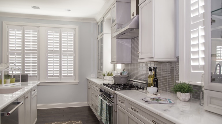 Plantation shutters in Southern California kitchen with white cabinets.